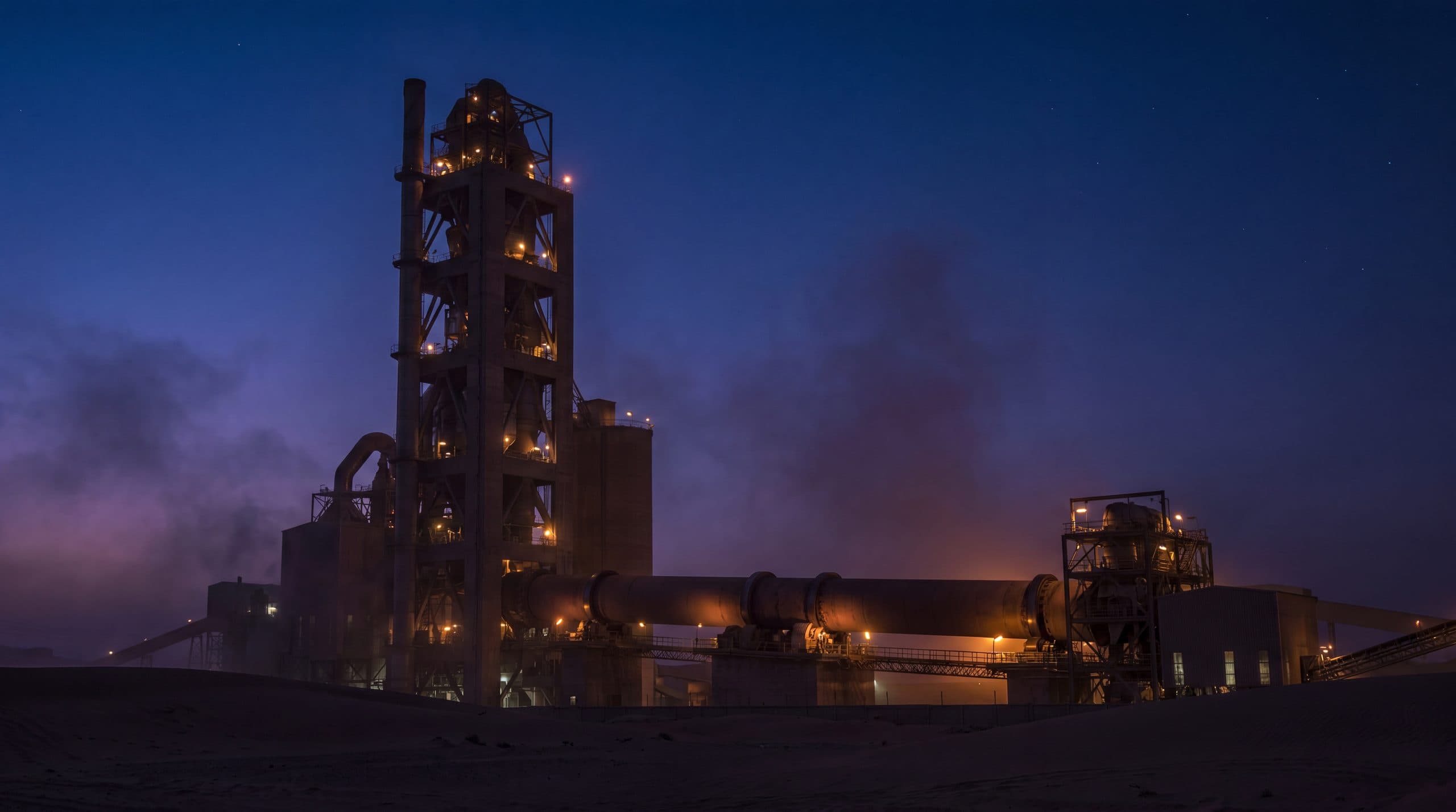 A cement plant in Saudi Arabia at dusk.