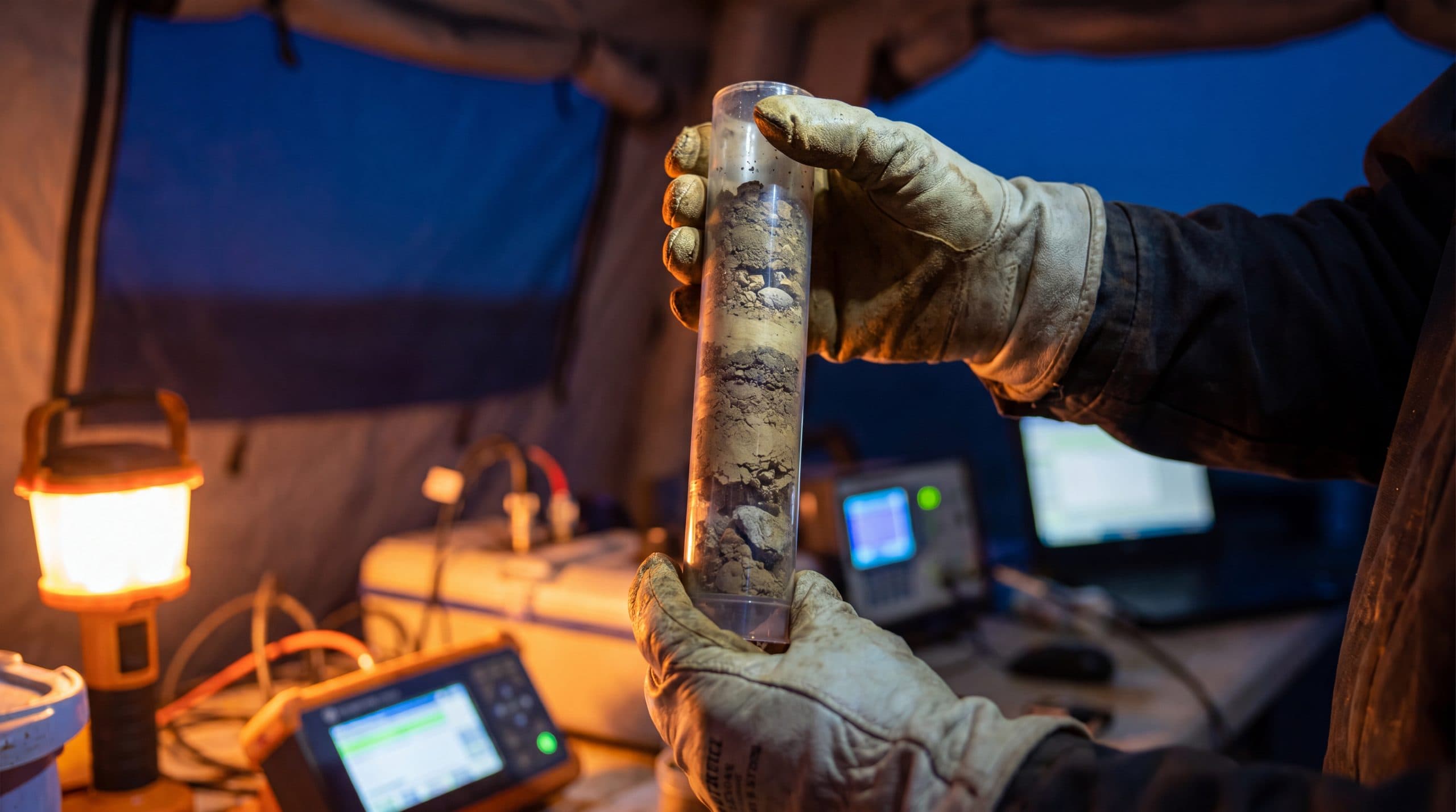 A technician taking a field sample and recording the reading.